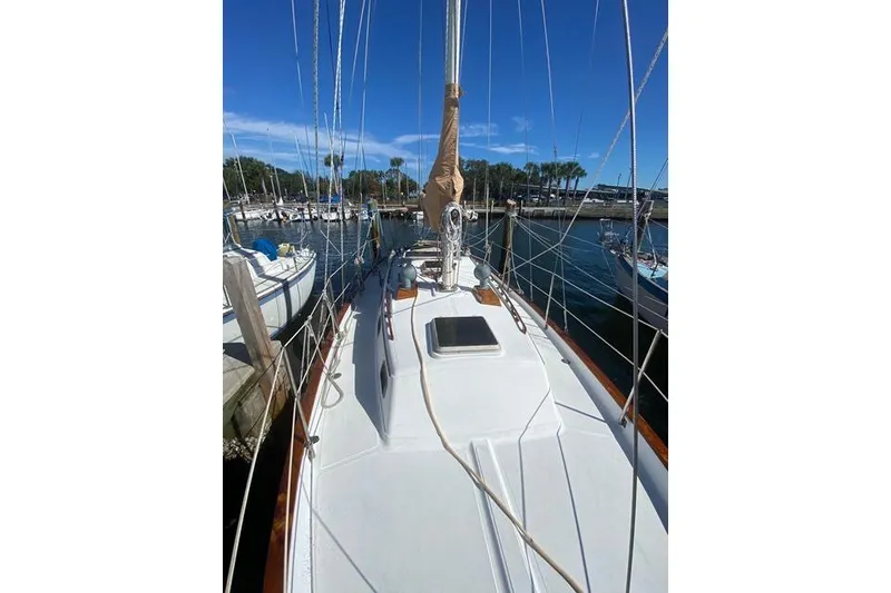 Slide: The Image of 1989 Pacific Seacraft Crealock sailboat docked at marina under clear blue sky. - 3