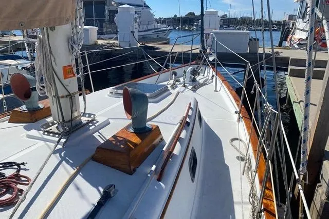 Slide: The Image of 1989 Pacific Seacraft Crealock sailboat docked at marina, showcasing deck and rigging. - 4