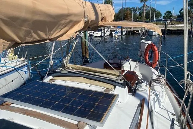 Slide: The Image of 1989 Pacific Seacraft Crealock sailboat with solar panel, docked at marina. - 6