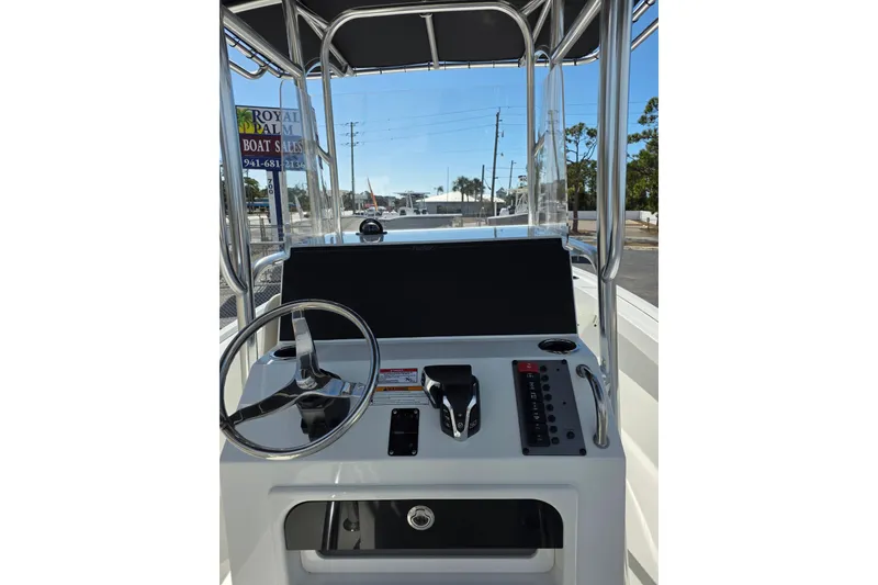 Slide: The Image of 2026 Parker 210 Coastal boat dashboard with steering wheel and control panel. - 10