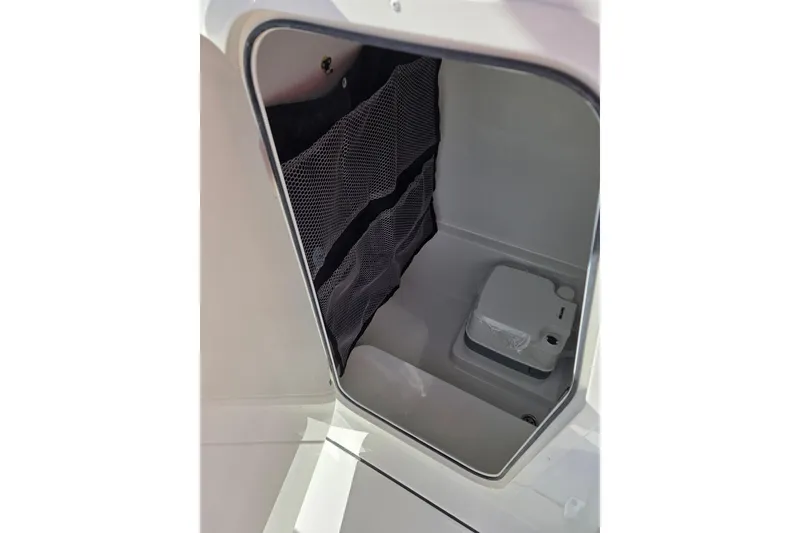 Slide: The Image of Interior storage compartment of 2026 Parker 210 Coastal boat with mesh pocket. - 16