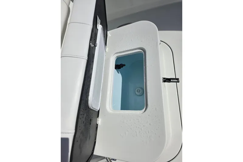 Slide: The Image of Open storage compartment on 2026 Parker 210 Coastal boat, showing interior details. - 21
