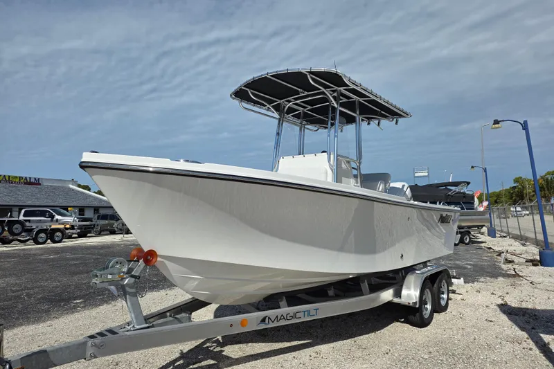 Slide: The Image of 2026 Parker 210 Coastal boat on trailer under clear sky. - 24