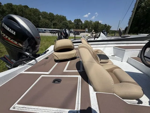 Slide: The Image of 2023 Xpress Boats H17C with Yamaha engine, featuring beige seating and spacious deck. - 3