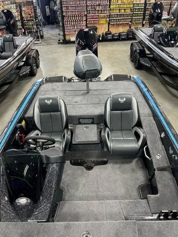 Slide: The Image of 2024 Phoenix Bass Boats 919 Elite with dual seats and sleek design in showroom. - 5