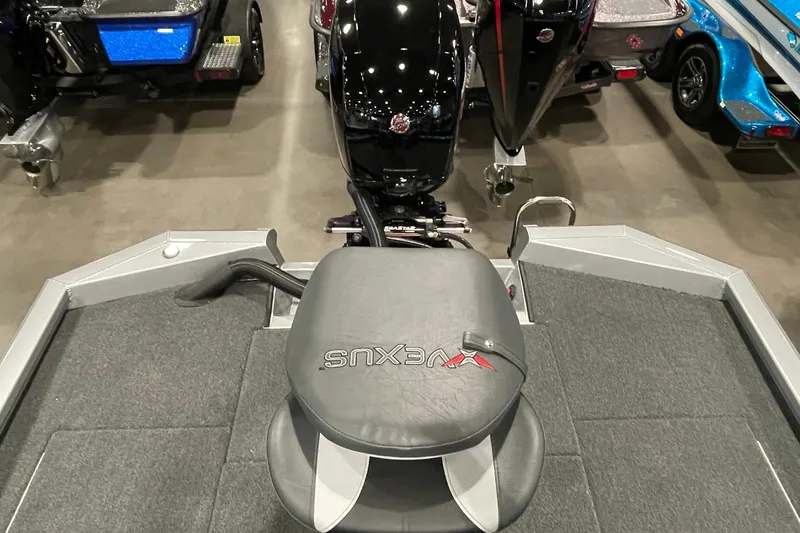 Slide: The Image of 2025 Vexus AVX1980C boat interior with motor and seating, displayed in showroom. - 6