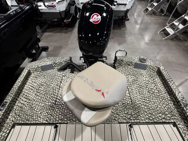 Slide: The Image of 2025 Vexus ACX2000 boat with patterned deck and branded seat in showroom. - 12