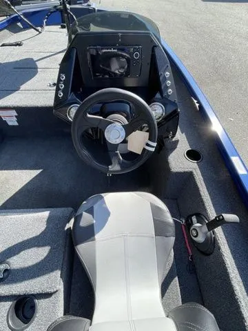 Slide: The Image of 2023 Crestliner XFC 179 boat interior with steering wheel and seating. - 6