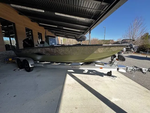The Image of 2025 Vexus ACX2150 boat on trailer under a metal canopy. - 1