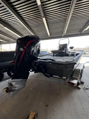 Slide: The Image of 2025 Vexus ACX2150 boat under shelter, showcasing powerful outboard motor and sleek design. - 3