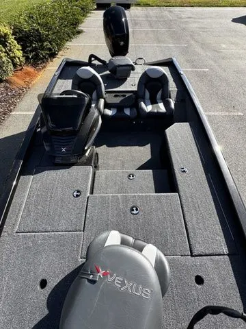 Slide: The Image of 2023 Vexus AVX181 boat with dual seats and modern design, parked on pavement. - 11