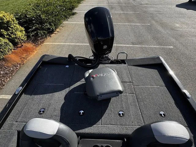 Slide: The Image of 2023 Vexus AVX181 boat interior with motor, parked in a lot. - 13