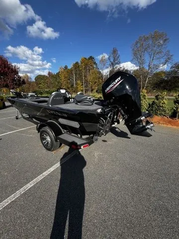 Slide: The Image of 2023 Vexus AVX181 boat with Mercury engine, parked outdoors on a sunny day. - 3