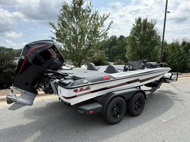 Slide: The Image of 2026 Bass Cat Pantera Classic boat on trailer, parked outdoors, with trees in background. - 3