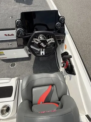 Slide: The Image of 2026 Bass Cat Pantera Classic boat interior with steering wheel and seat, featuring modern design elements. - 6