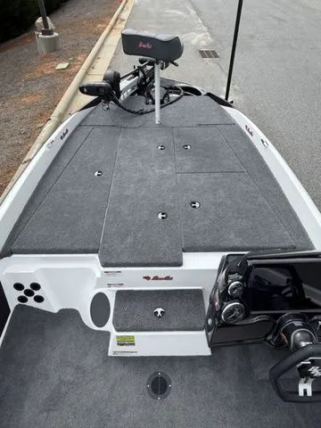 Slide: The Image of 2026 Bass Cat Pantera Classic boat deck with gray carpeting and control panel. - 8