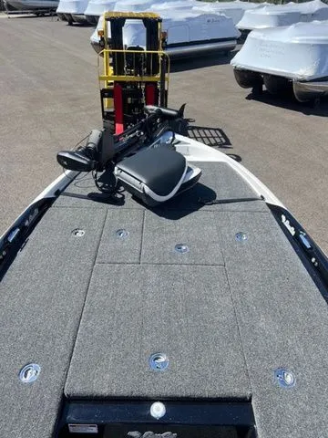 Slide: The Image of 2026 Bass Cat Cougar FTD SP boat deck with trolling motor, parked in a marina. - 3