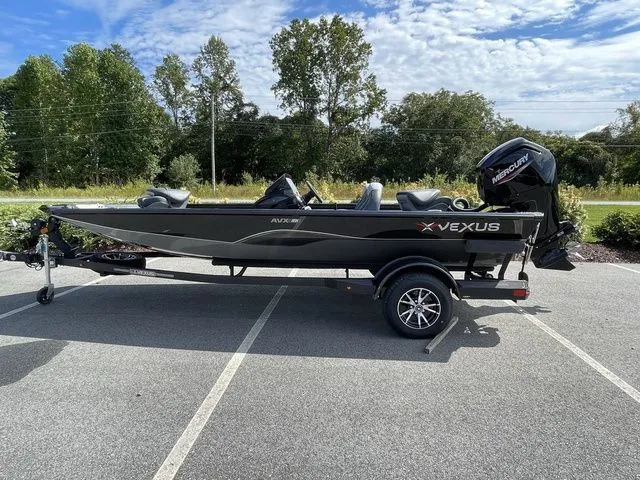 The Image of 2023 Vexus AVX181 boat on trailer, parked outdoors with trees in background. - 1