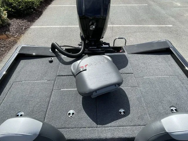 Slide: The Image of 2023 Vexus AVX181 boat deck with seating and motor, parked on asphalt. - 14