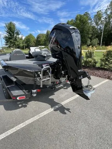 Slide: The Image of 2023 Vexus AVX181 boat with powerful outboard motor, parked outdoors on a sunny day. - 3