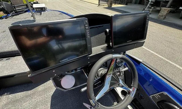 Slide: The Image of 2024 Vexus VXS20 boat dashboard with dual Garmin displays and steering wheel. - 8