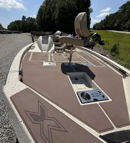 Slide: The Image of 2022 Xpress Boats H17C fishing boat with spacious deck and seating, set outdoors. - 4