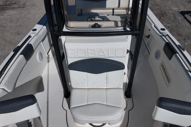 Slide: The Image of 2021 Robalo R222 Center Console boat interior with seating and console view. - 13