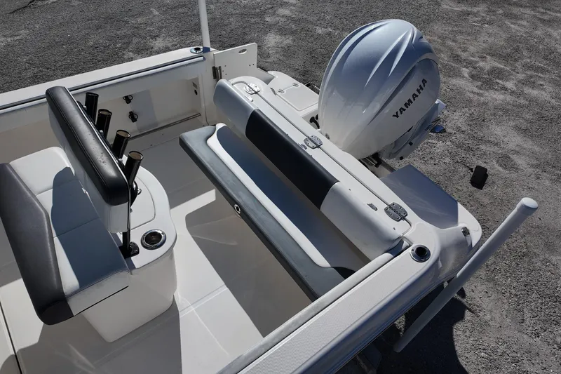 Slide: The Image of 2021 Robalo R222 Center Console boat with Yamaha engine, featuring seating and rod holders. - 16