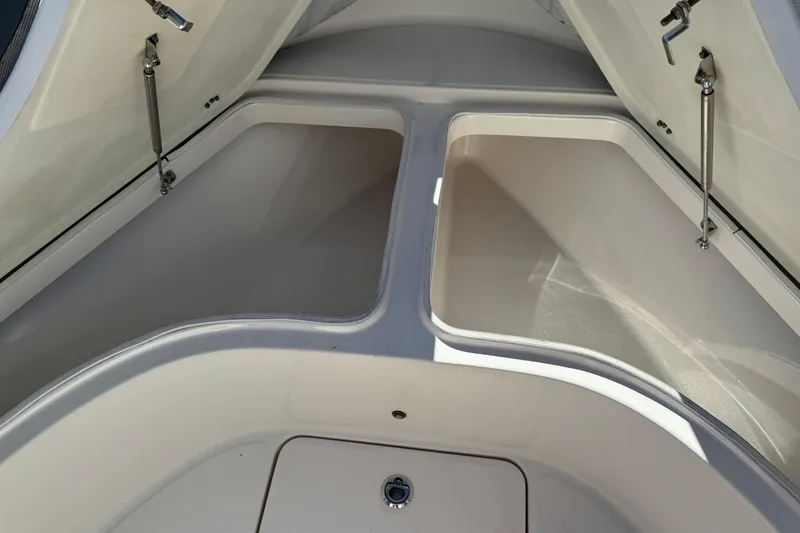 Slide: The Image of 2021 Robalo R222 Center Console storage compartments open, showcasing spacious interior design. - 18