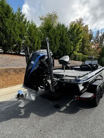 Slide: The Image of 2024 Phoenix Bass Boats 20 XE, sleek design, powerful engine, parked outdoors. - 3