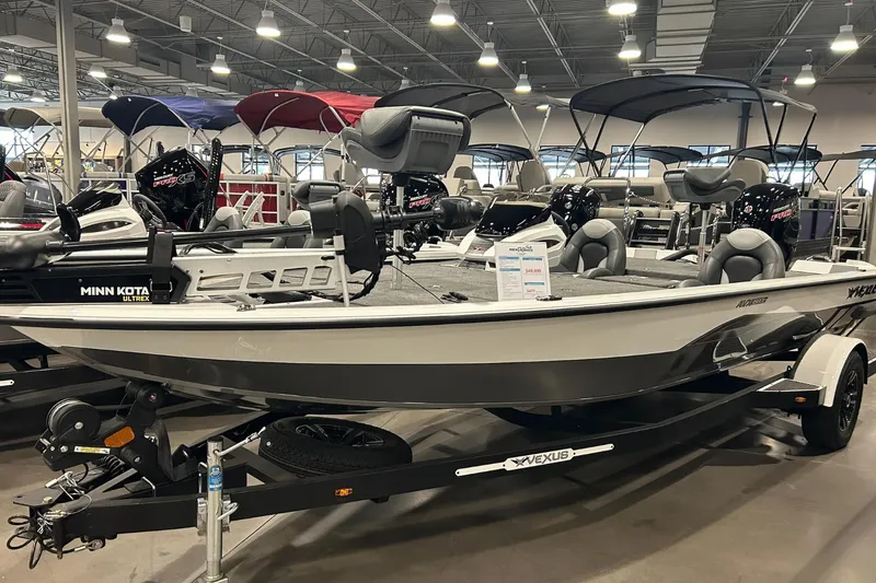 The Image of 2024 Vexus AVX1880C fishing boat displayed indoors with Minn Kota motor. - 0