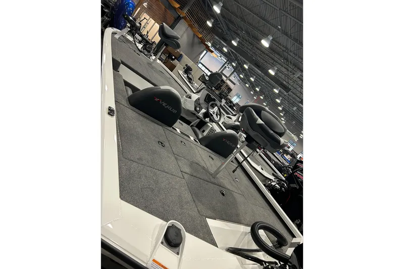 Slide: The Image of Clothing store interior with 2024 Vexus AVX1880C boats in the background. - 6