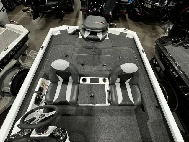 Slide: The Image of 2024 Vexus AVX1980C boat interior with gray seating and steering wheel, showcasing spacious design. - 13