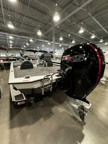 Slide: The Image of 2024 Vexus AVX1980C boat with powerful engine, showcased in a well-lit indoor setting. - 2