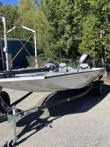 The Image of 2023 G3 Sportsman 1710 boat on trailer, parked outdoors near trees. - 1