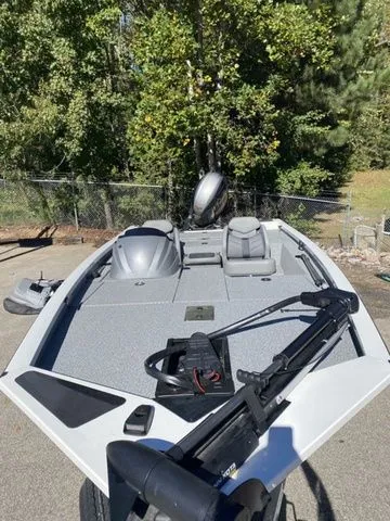 Slide: The Image of 2023 G3 Sportsman 1710 boat with trolling motor, parked outdoors. - 2