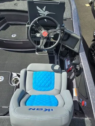 Slide: The Image of 2026 Ikon Boats LXE20 cockpit with steering wheel and blue-accented seat. - 4