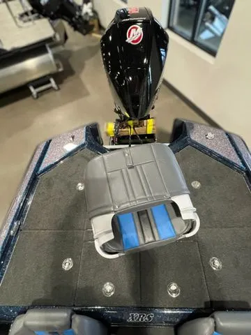 Slide: The Image of 2023 Bullet 21XRS boat with sleek design and powerful engine, showcased indoors. - 10