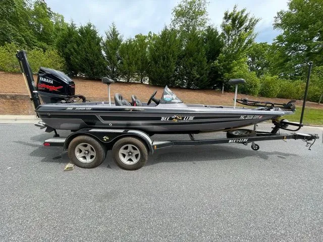 The Image of 2008 Bee Line Super Vee boat with Yamaha motor on a trailer, parked outdoors. - 1