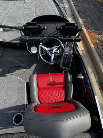 Slide: The Image of 2024 Vexus VXS20 boat interior with red and gray seating, modern steering, and control panel. - 6