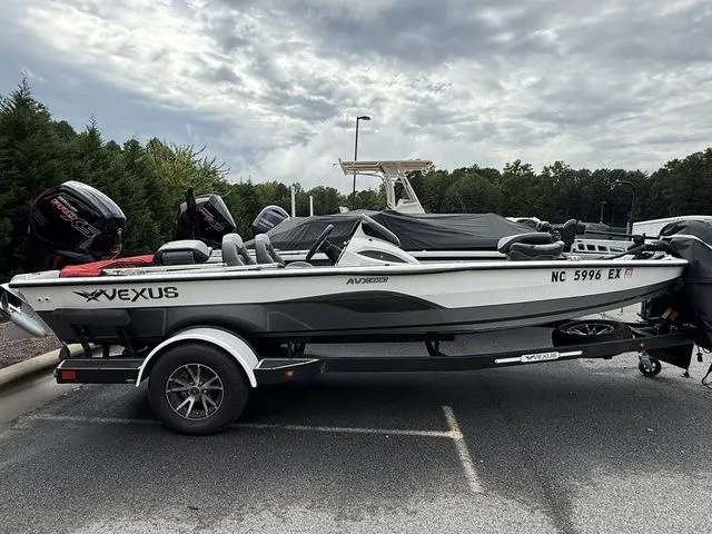 The Image of 2022 Vexus AVX1880 boat on trailer in parking lot, cloudy sky background. - 1