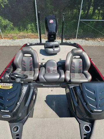 Slide: The Image of 2018 Nitro Z21 boat with dual seats and powerful engine, parked on pavement. - 5