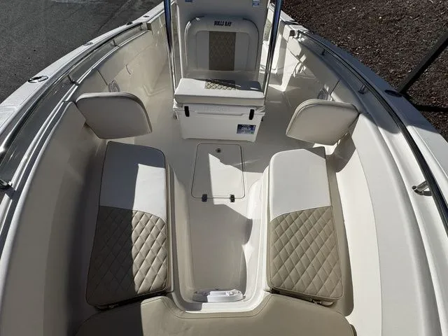 Slide: The Image of 2025 Bulls Bay 255CC boat interior with cushioned seating and storage compartments. - 10