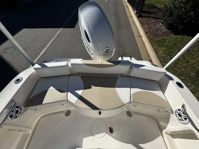 Slide: The Image of 2025 Bulls Bay 200CC boat interior with cushioned seating and outboard motor. - 11