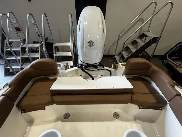 Slide: The Image of 2025 Pioneer ISLANDER 202 boat interior with brown seating and Suzuki outboard motor. - 12