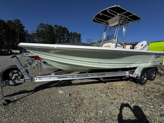 Slide: The Image of 2025 Bulls Bay 2200 XS boat on trailer, parked outdoors under clear blue sky. - 2
