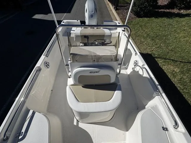 Slide: The Image of 2025 Bulls Bay 2000 boat interior with seating and steering console, parked on a driveway. - 8