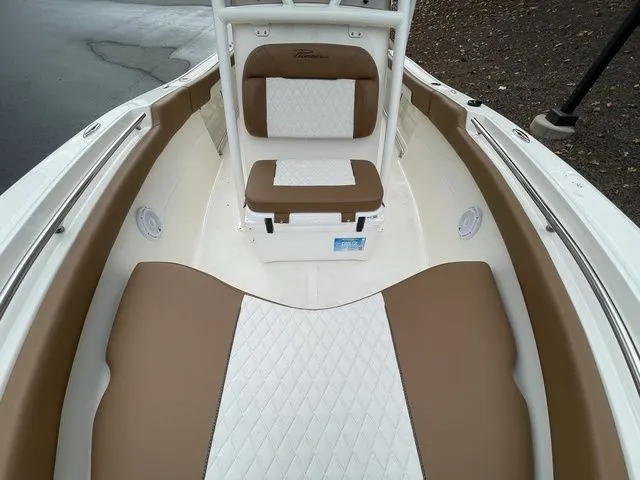 Slide: The Image of 2024 Pioneer Sportfish 202 boat interior with brown and white cushioned seating. - 9