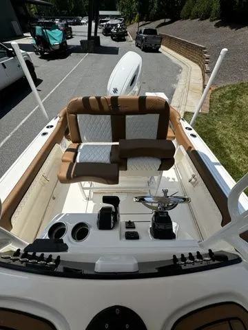 Slide: The Image of 2025 Pioneer ISLANDER 202 boat interior with brown and white seating, steering wheel, and controls. - 10