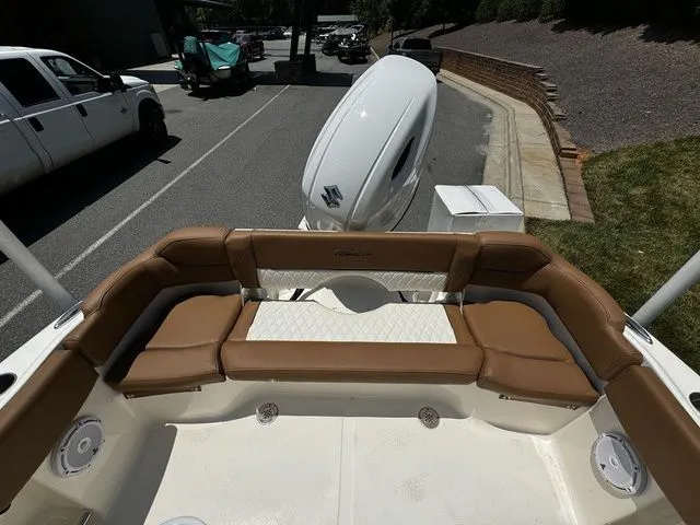 Slide: The Image of 2025 Pioneer ISLANDER 202 boat with brown seating and Suzuki outboard motor. - 12